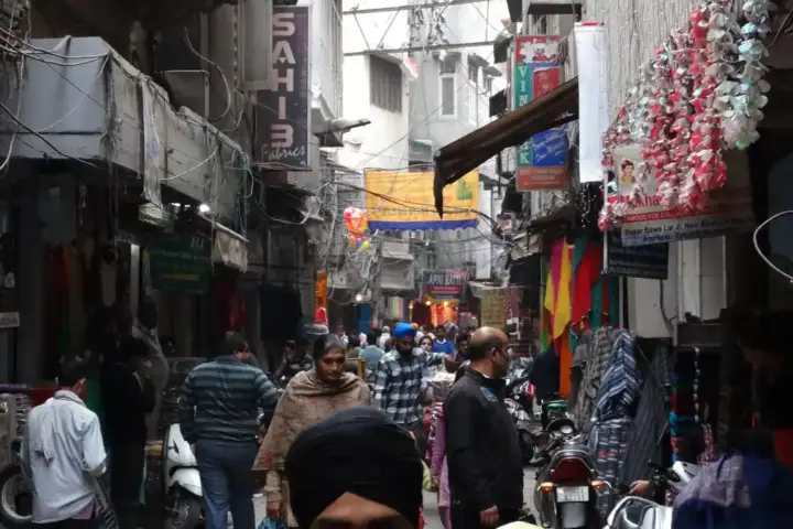 Commercial street scene with vehicles and storefronts in Amritsar Punjab