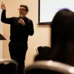 Andy Burnham speaking at a public event in 2024