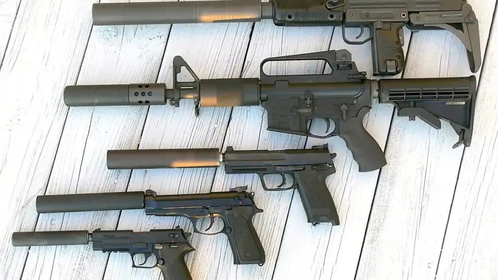 Cylindrical metallic firearm sound suppressors showing machined threads and modular baffle design.