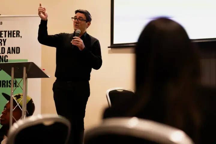 Andy Burnham speaking at a public event in 2024