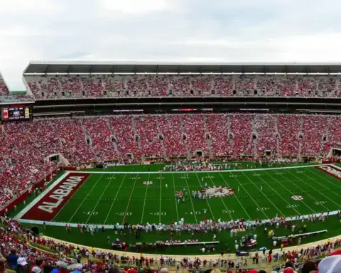 Panoramic view of the full grandstands, field, and upper decks of Bryant-Denny Stadium during a collegiate athletic event in Alabama.