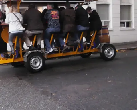 Open-air pedal tavern carrying multiple passengers along a city street, similar to the vehicle involved in the Nashville crash