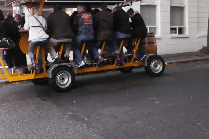 Open-air pedal tavern carrying multiple passengers along a city street, similar to the vehicle involved in the Nashville crash