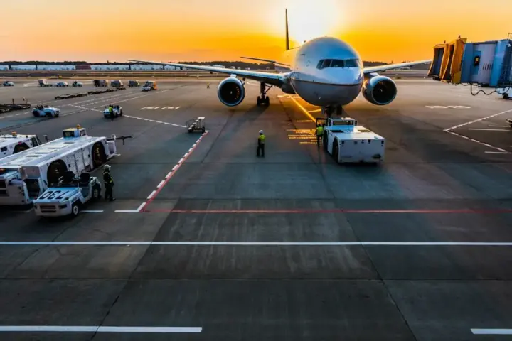 Commercial jet aircraft landing on an airport tarmac runway during flight operations