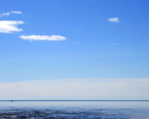 A small vessel on Lake Superior under open sky.