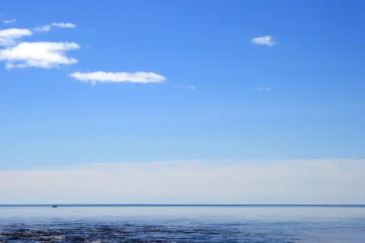 A small vessel on Lake Superior under open sky.