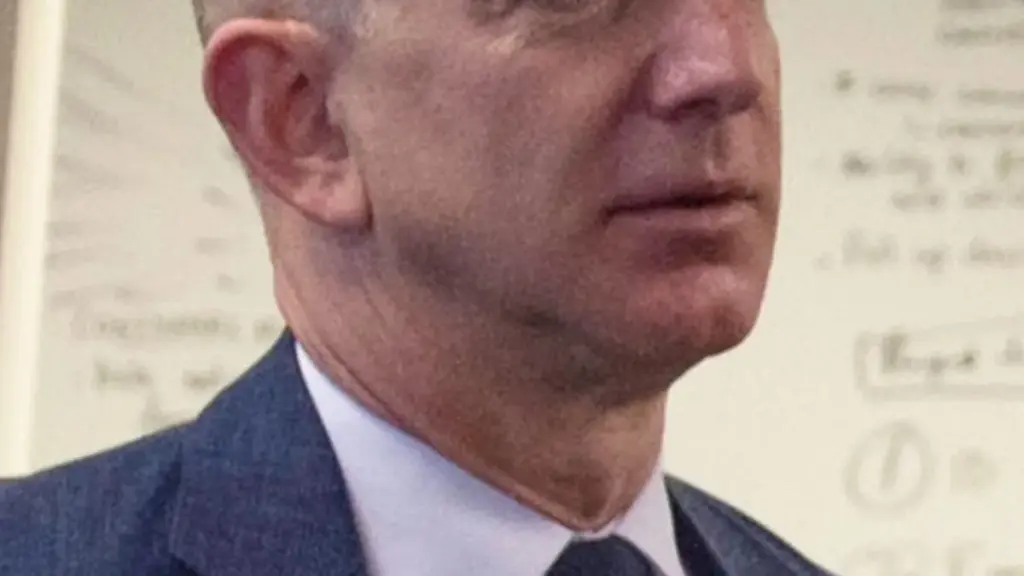 Formal portrait photograph of Amazon founder Jeff Bezos speaking during an official executive gathering.