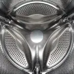 Inside a front-loading washing machine drum, illustrating laundry microfibre shedding