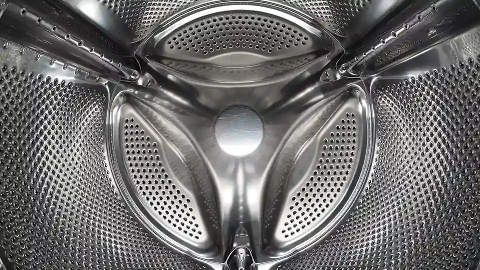 Inside a front-loading washing machine drum, illustrating laundry microfibre shedding