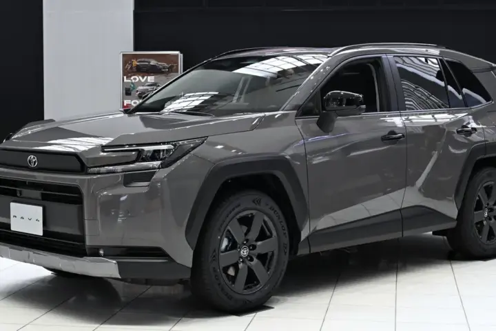 Front three-quarter view of a modern Toyota RAV4 Hybrid crossover parked on pavement.