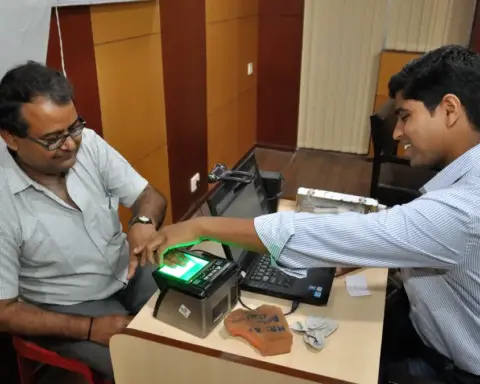 Person placing fingers on a biometric scanner during identity enrollment
