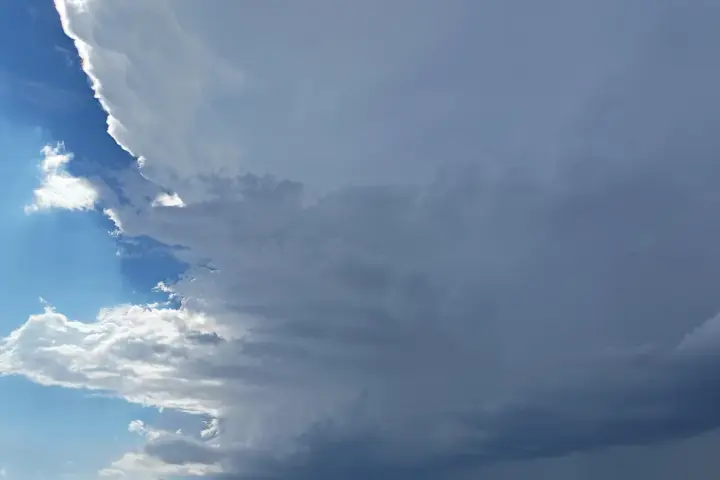 Dark supercell thunderstorm clouds building over the landscape, similar to the system that struck northern Arizona