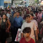 Dense crowd of devotees moving through a narrow Kolkata street during a Durga Puja festival night