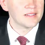 Texas State Representative James Talarico speaking into a microphone at an open civic conference in Austin, Texas