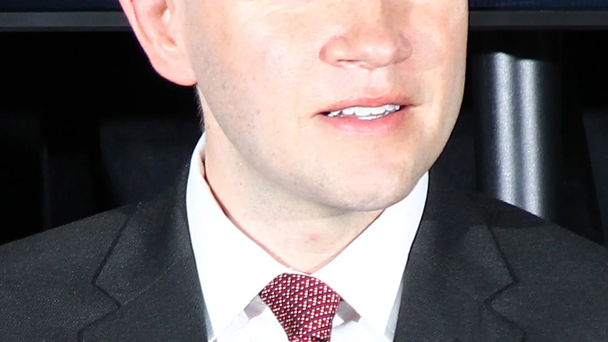 Texas State Representative James Talarico speaking into a microphone at an open civic conference in Austin, Texas