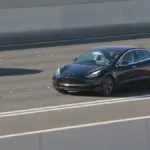 Tesla Model 3 driving on a public road