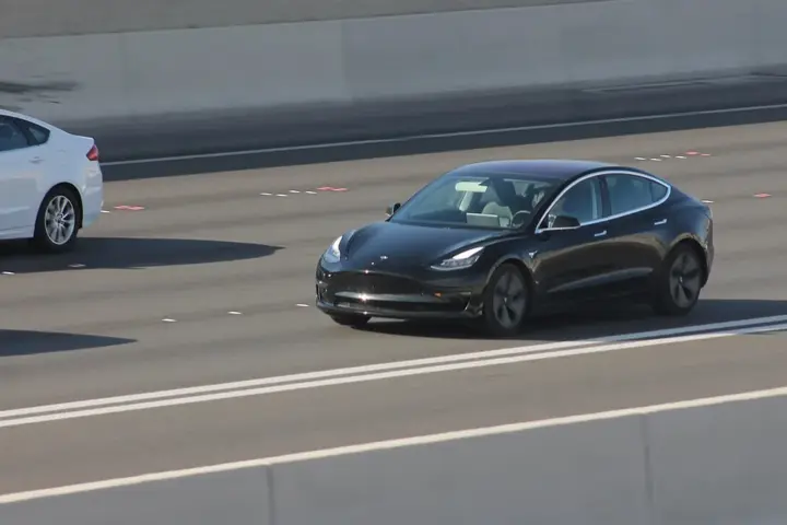 Tesla Model 3 driving on a public road