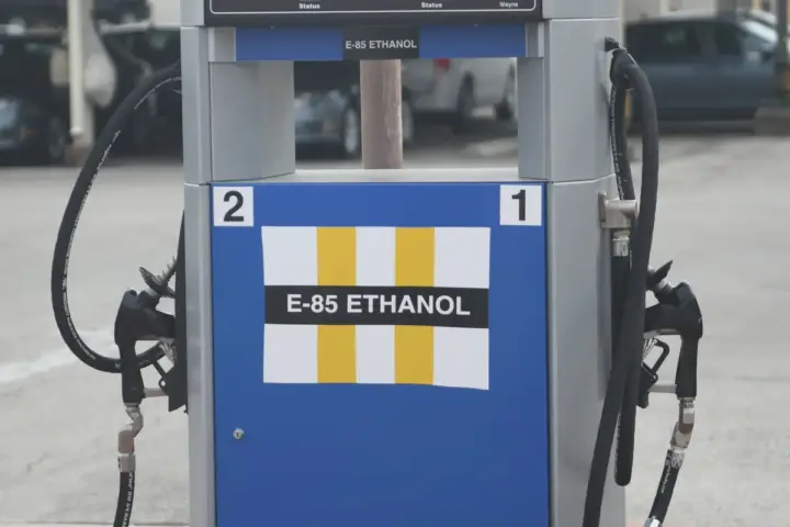 Close-up photograph of a commercial automotive fuel dispenser with pump nozzles mounted at a service station in Texas.