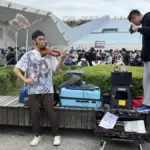 Person using smartphone to record video content, holding phone steady while capturing another activity
