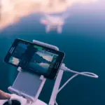 A person holding a smartphone and watching a video on a social media app