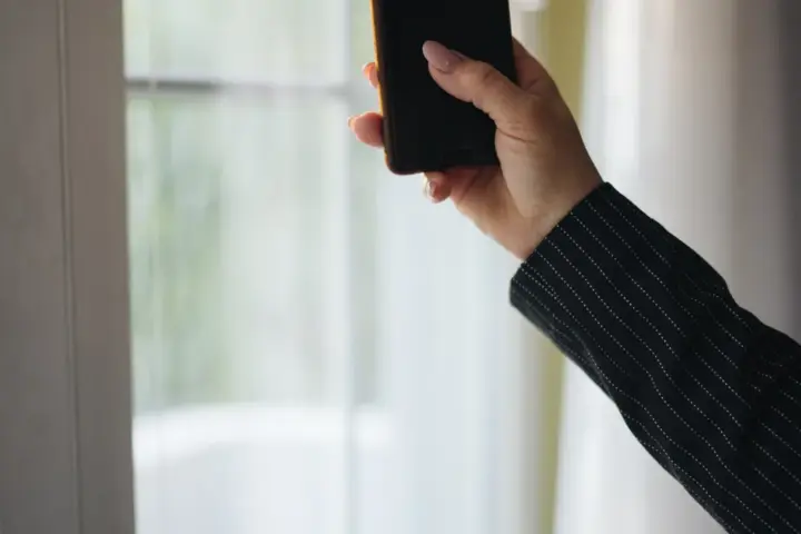 A person holding and using a smartphone in their hands