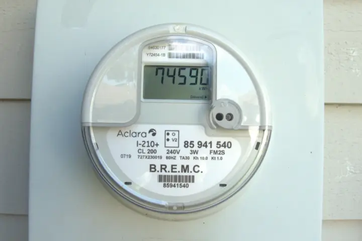 Close-up photograph of a wall-mounted single-phase smart digital electricity meter.
